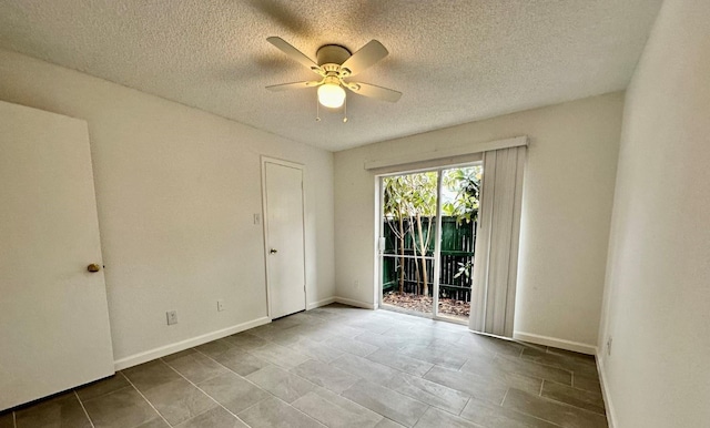 unfurnished room featuring a textured ceiling, baseboards, and a ceiling fan