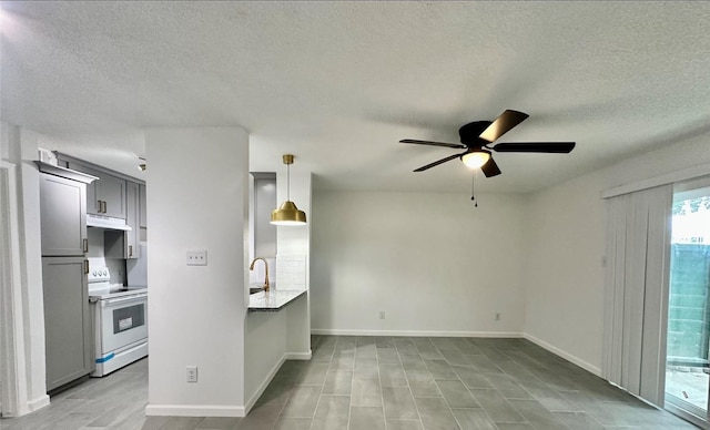1516 Bay Area Blvd Unit S6, B9, E7, S11, K15, K3, Houston, TX 77058 - unfurnished living room with baseboards, ceiling fan, a sink, and a textured ceiling
