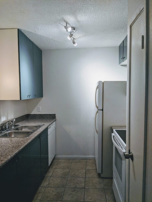 1516 Bay Area Blvd Unit S6, B9, E7, S11, K15, K3, Houston, TX 77058 - kitchen with a textured ceiling, white appliances, dark countertops, dark tile patterned flooring, and a sink