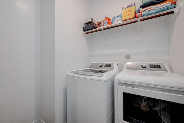 washroom featuring washer and clothes dryer