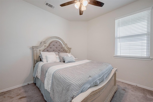 bedroom featuring light colored carpet and ceiling fan