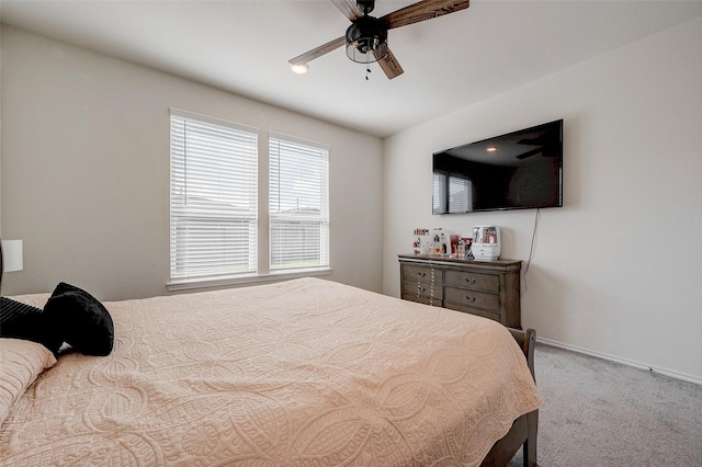 bedroom with ceiling fan and light carpet