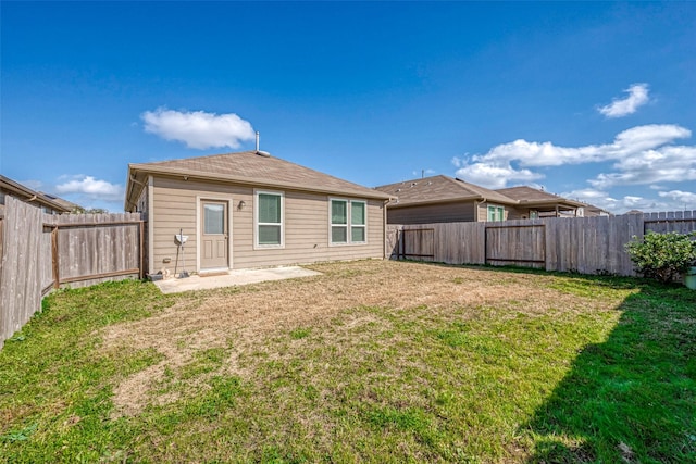 back of property featuring a yard and a patio area