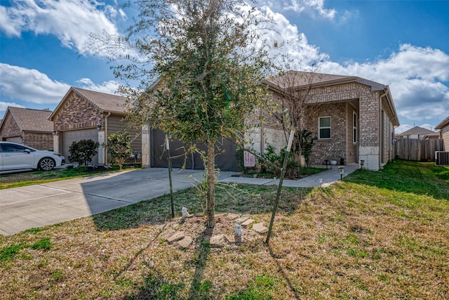 view of front of property with a garage, central AC unit, and a front yard