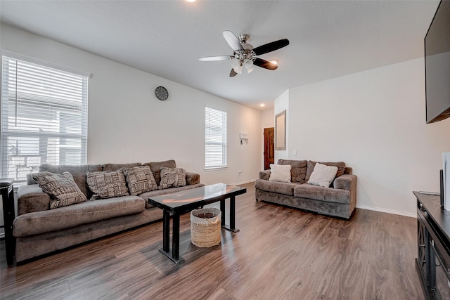 living room featuring hardwood / wood-style flooring and ceiling fan