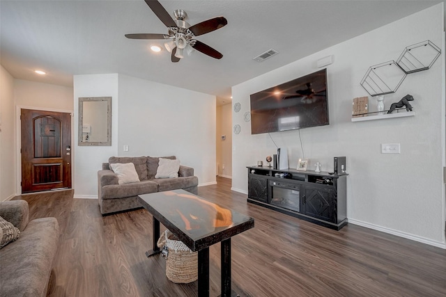 living room with ceiling fan and dark hardwood / wood-style flooring