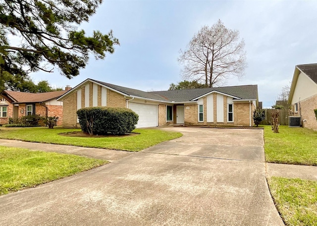 single story home with a garage, central AC, and a front lawn