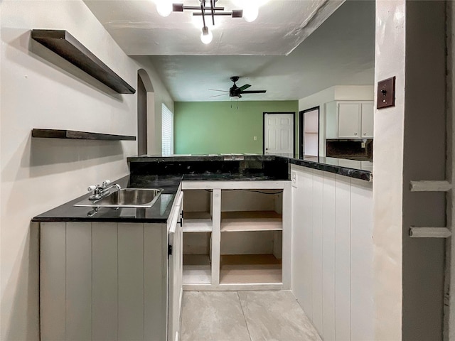 kitchen with ceiling fan, sink, and white cabinets