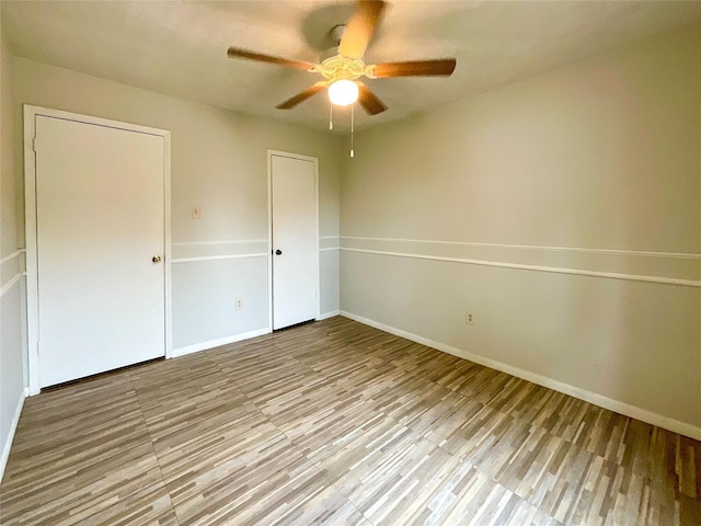 spare room featuring ceiling fan and light hardwood / wood-style floors