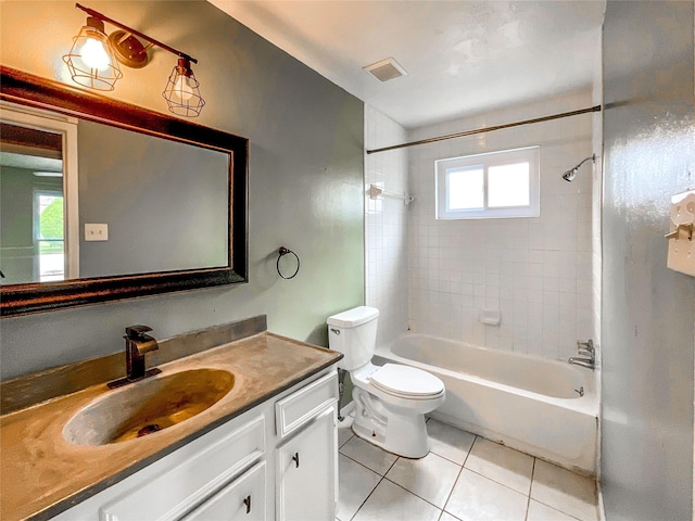 full bathroom featuring vanity, tile patterned flooring, toilet, and tiled shower / bath combo