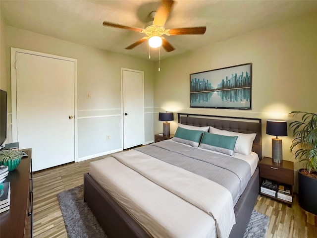 bedroom with light hardwood / wood-style flooring and ceiling fan