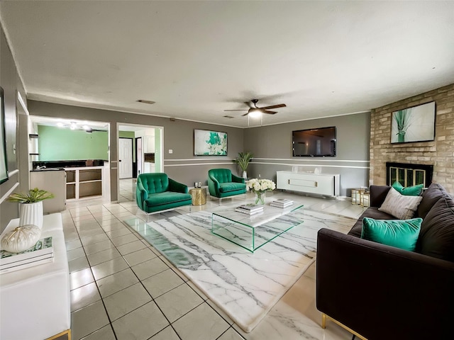 living room featuring ceiling fan and a fireplace