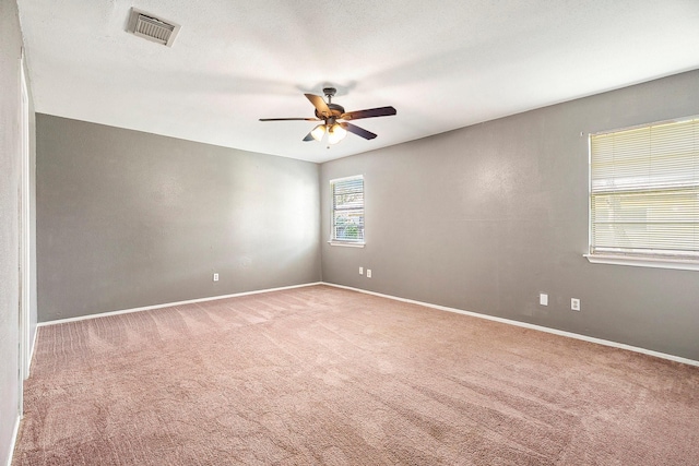 carpeted empty room with ceiling fan and a textured ceiling