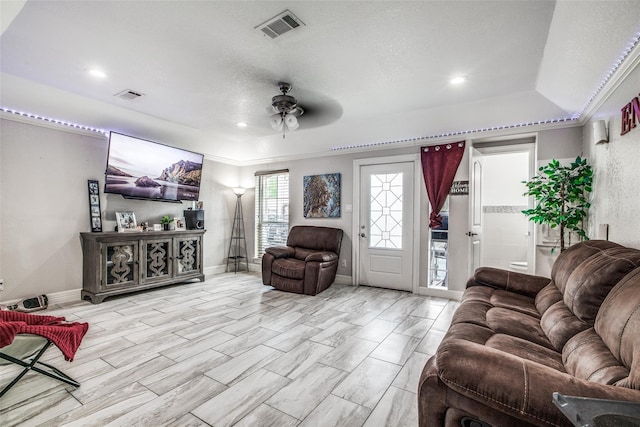 living room featuring crown molding and ceiling fan