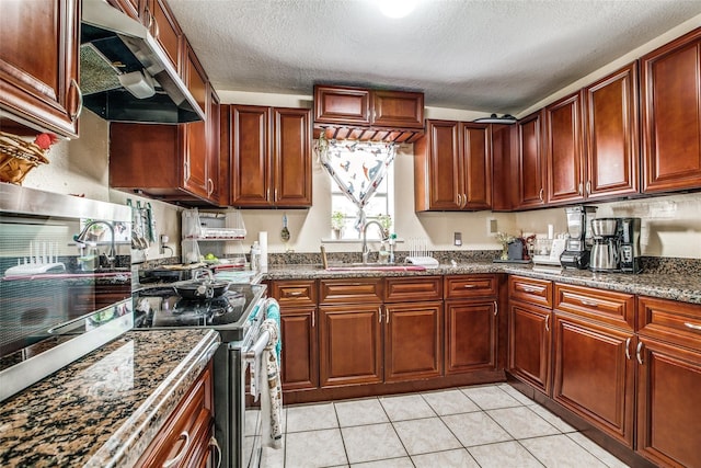 kitchen with sink, dark stone countertops, electric range, and light tile patterned floors