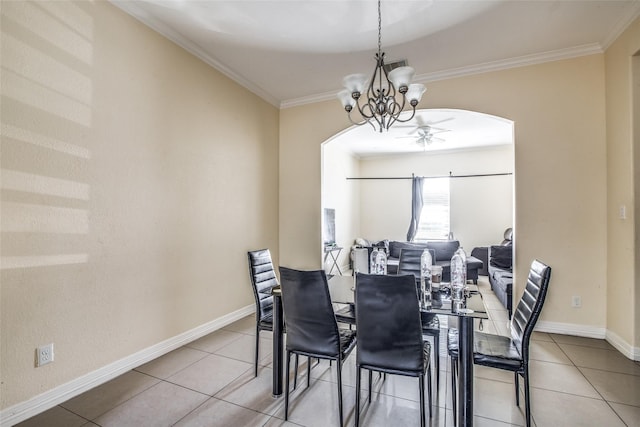 dining space with tile patterned flooring, ornamental molding, and a notable chandelier