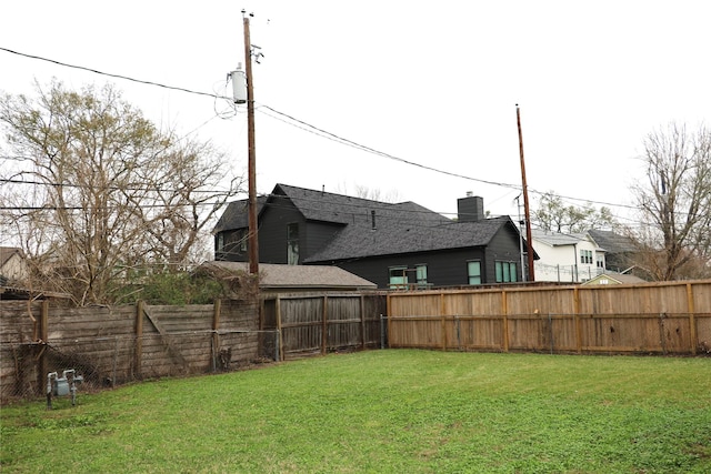 view of yard with central air condition unit and a fenced backyard