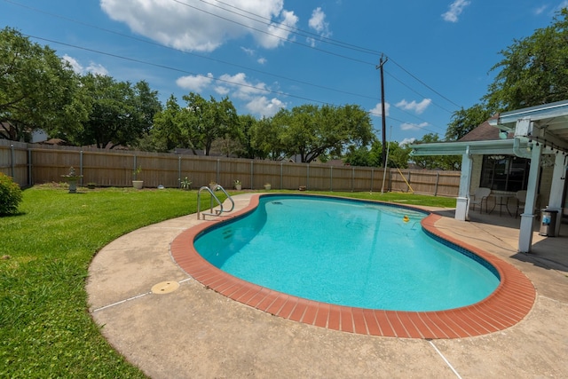 view of swimming pool with a yard and a patio