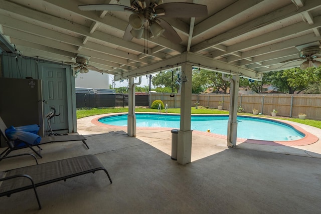 view of swimming pool featuring ceiling fan and a patio area