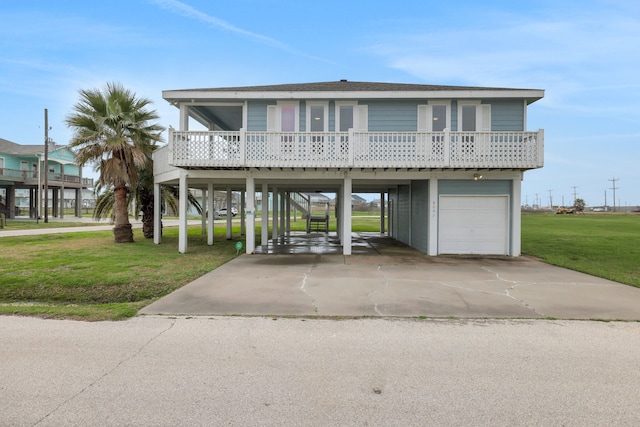 coastal home with a porch, a garage, stairway, a carport, and a front lawn