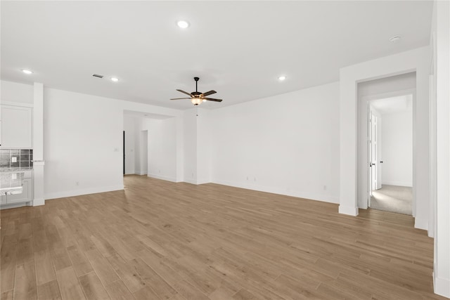 32626 Fly Fish Way, Fulshear, TX 77441 - unfurnished living room featuring a ceiling fan, recessed lighting, light wood finished floors, and baseboards