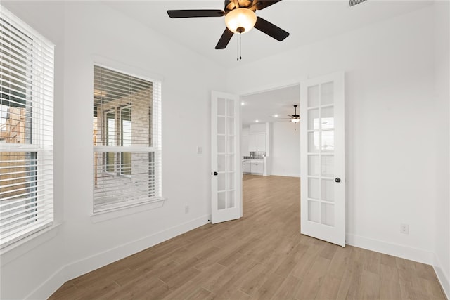 32626 Fly Fish Way, Fulshear, TX 77441 - unfurnished room featuring french doors, a ceiling fan, light wood-style flooring, and baseboards