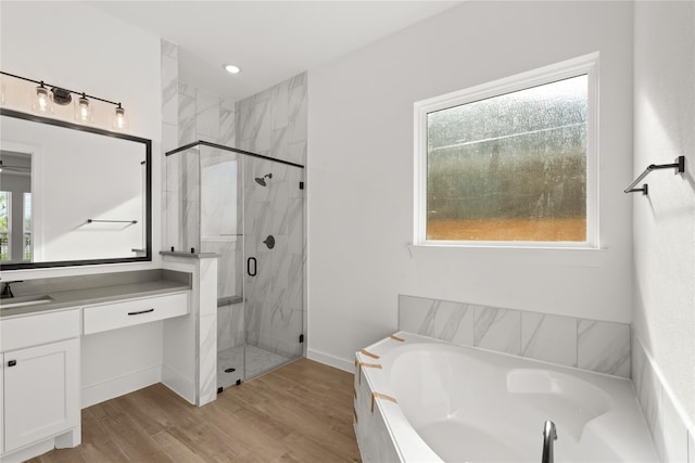 32626 Fly Fish Way, Fulshear, TX 77441 - bathroom with a bath, vanity, a marble finish shower, and wood finished floors