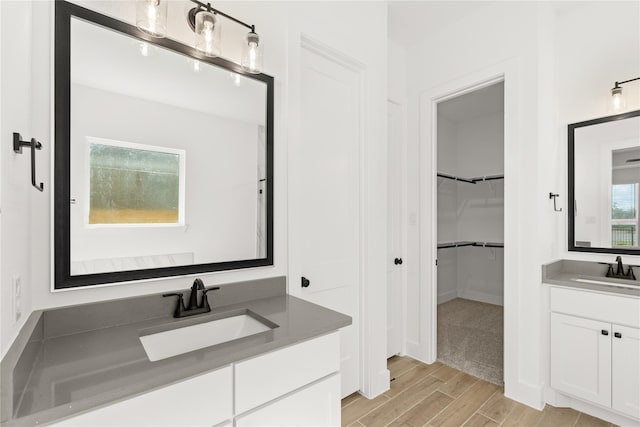 32626 Fly Fish Way, Fulshear, TX 77441 - full bath featuring two vanities, wood finished floors, and a walk in closet