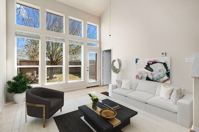 living room featuring a high ceiling and tile patterned floors