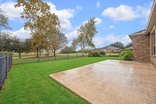 view of yard featuring a patio area and a fenced backyard