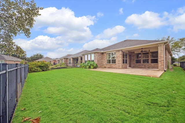 back of house featuring ceiling fan, a yard, and a patio area