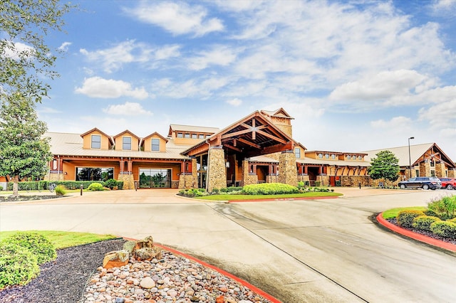 view of front facade with stone siding and metal roof