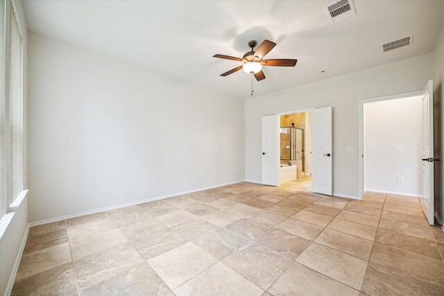 unfurnished bedroom featuring ceiling fan, baseboards, visible vents, and connected bathroom