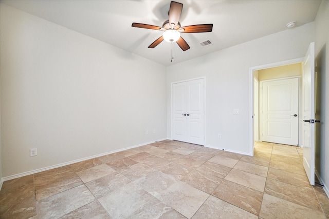 spare room featuring visible vents, baseboards, and ceiling fan