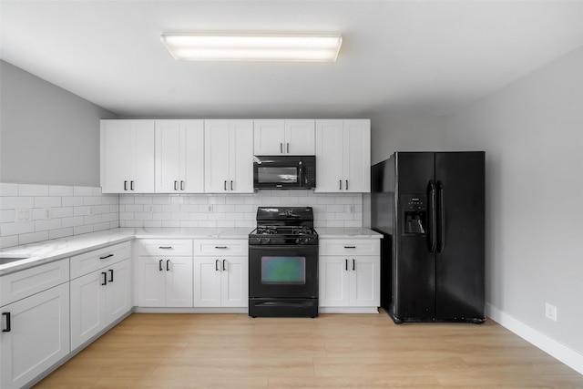 kitchen featuring white cabinetry and black appliances