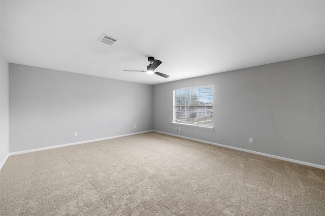 spare room featuring ceiling fan and light colored carpet