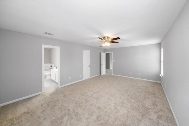 unfurnished bedroom featuring ceiling fan, connected bathroom, and light carpet