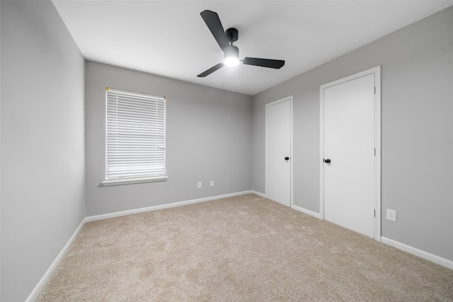 unfurnished bedroom with light carpet and ceiling fan