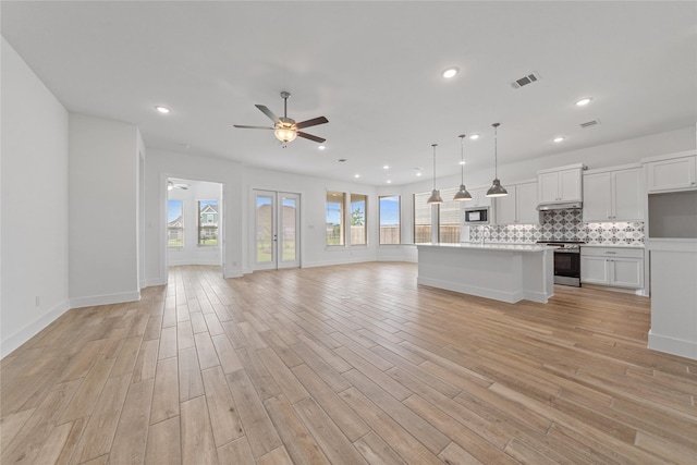 32646 Fly Fish Way, Fulshear, TX 77441 - unfurnished living room with ceiling fan, light wood finished floors, recessed lighting, and baseboards