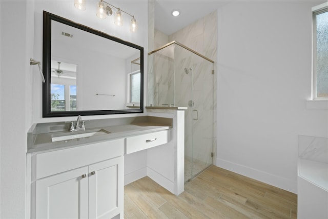 32646 Fly Fish Way, Fulshear, TX 77441 - bathroom featuring vanity, wood finished floors, a marble finish shower, and baseboards