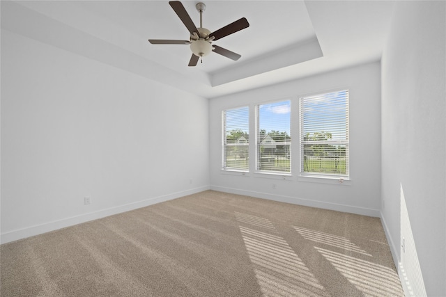32646 Fly Fish Way, Fulshear, TX 77441 - empty room featuring baseboards, light colored carpet, a tray ceiling, and ceiling fan