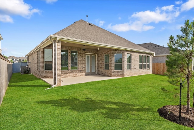 32646 Fly Fish Way, Fulshear, TX 77441 - back of house featuring brick siding, a patio, and roof with shingles