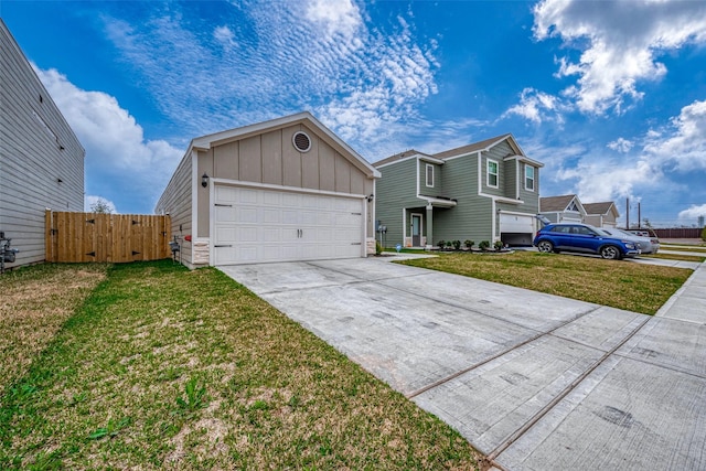 view of front of house with board and batten siding, a gate, a garage, driveway, and a front lawn