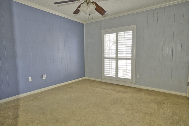 empty room with crown molding, carpet floors, and ceiling fan