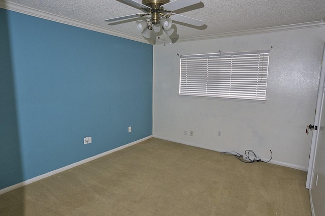 carpeted empty room with ceiling fan, crown molding, and a textured ceiling