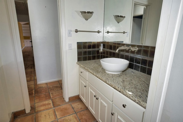 bathroom featuring vanity and backsplash