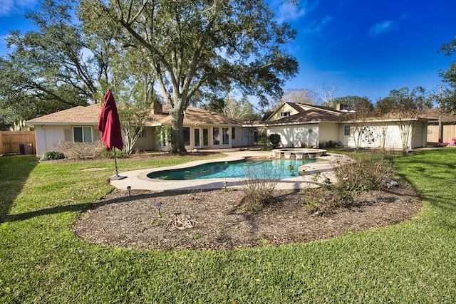 view of swimming pool with an in ground hot tub and a lawn