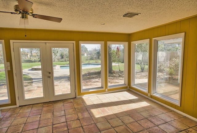 unfurnished sunroom with french doors