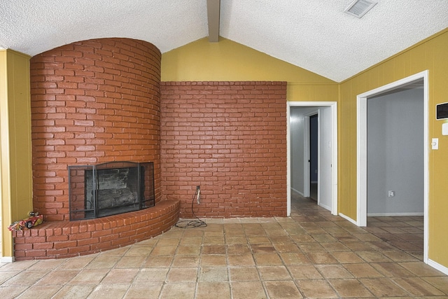 unfurnished living room with a brick fireplace, tile patterned floors, lofted ceiling with beams, and a textured ceiling