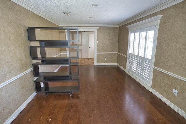 unfurnished room featuring crown molding, dark wood-type flooring, and a textured ceiling